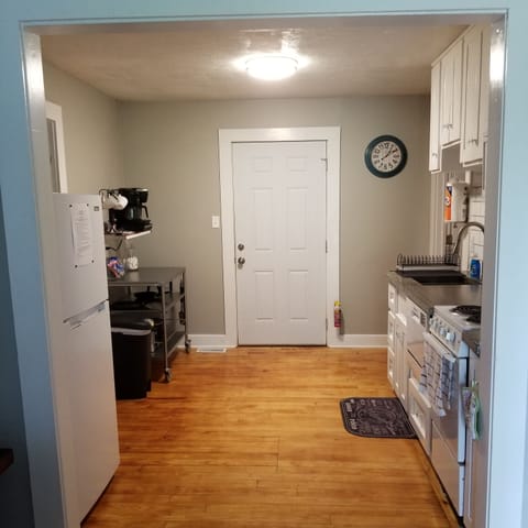 Full kitchen: microwave, stove/oven, prep cart, keurig, refrigerator, & DW.