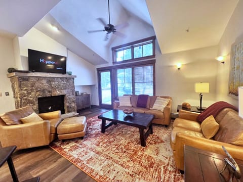 Great room with floor to ceiling windows and vaulted ceilings