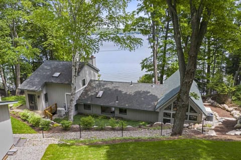 FIRST IMPRESSION: STUNNING VIEW of house and lake as you approach from the road