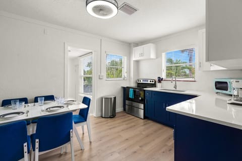 Siesta Key beach retreat kitchen with clean design, ocean-blue cabinets, and bright natural light—crafted for breezy meals and laid-back coastal living.