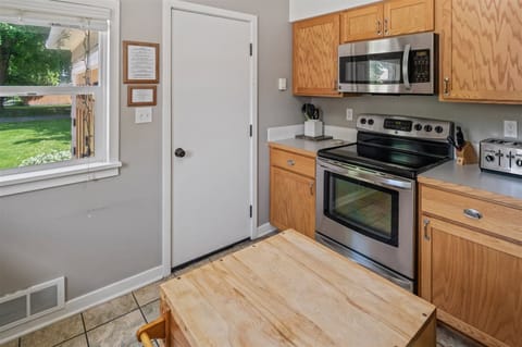 Well-equipped kitchen with a dishwasher, microwave, and toaster, conveniently located near the back door for easy access.