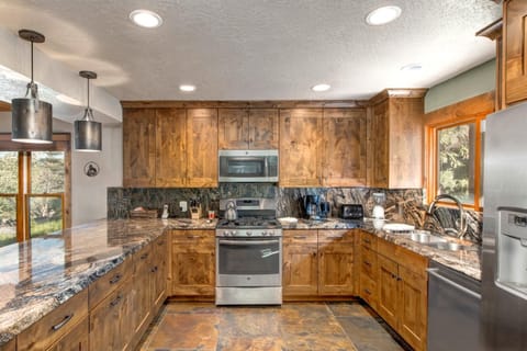 Spacious kitchen offers double ovens, generous prep space, and a central layout for group meals.
