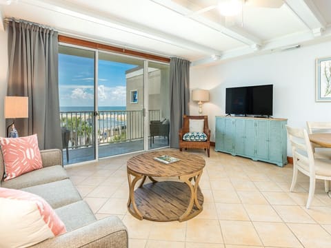 Living room opens to balcony with views of the pools and the Atlantic Ocean