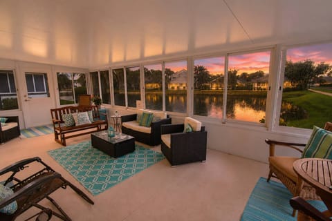 Relax on the spacious enclosed lanai, featuring peaceful waterfront views and an inviting spot to enjoy colorful Florida sunsets over the water.