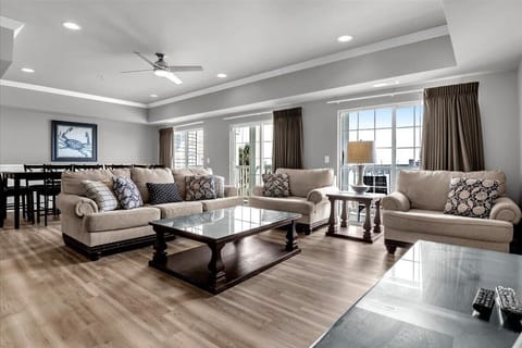 Living room with view of dining area and Oceanfront view