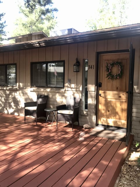 The shady deck in the front of the home.