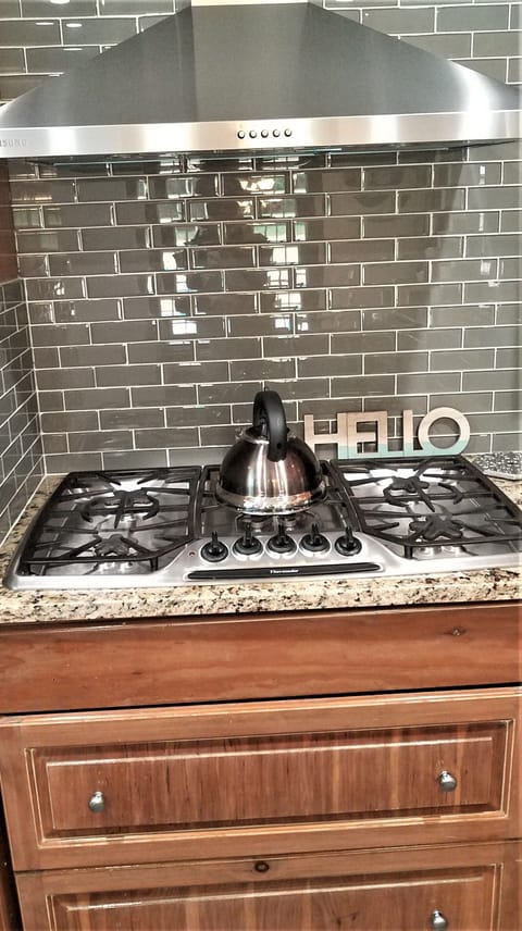5 burner gas stove. Custom designed backsplash. Plenty of storage for pots, pans