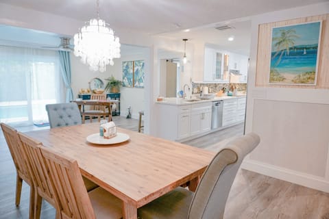 Spacious open plan area. The Dining table has 5 chairs and a bench - seats 8