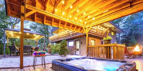 Enjoy the hot tub during all seasons as the rooftop will shelter you from rain. Also notice the balcony that wraps half way around the house - a perfect spot to enjoy the natural surroundings.