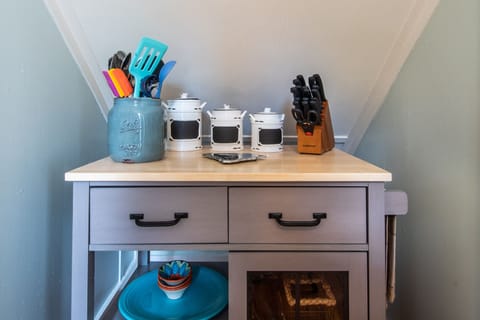 Portable pantry under staircase next to kitchen