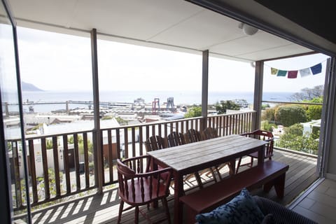 Veranda view off open plan kitchen and lounge with stacking doors open.