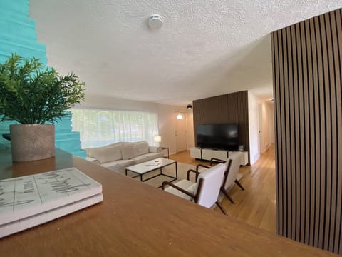 Gather around in the living room with plenty of seating to watch your favorite movies on the 65" Smart TV, work on a puzzle, or just hang out.