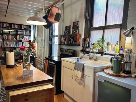 Industrial loft kitchen with butcher block island and dining table
