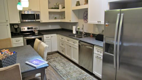 Stove, oven, coffee maker, microwave, dishwasher and fridge. 