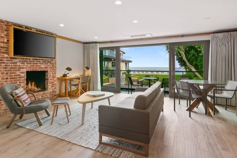 Get cozy next to the crackling fireplace as you take in views of the expansive Pacific Ocean.