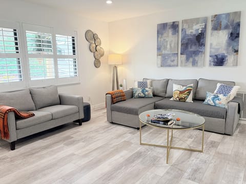 Enter the front door into the living room with comfortable seating for 7+