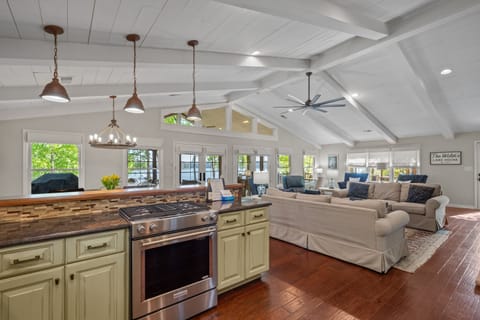 Open kitchen with views of lake, living room and porch all in one open space