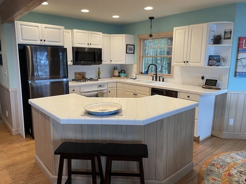 Kitchen with island and new black stainless appliances