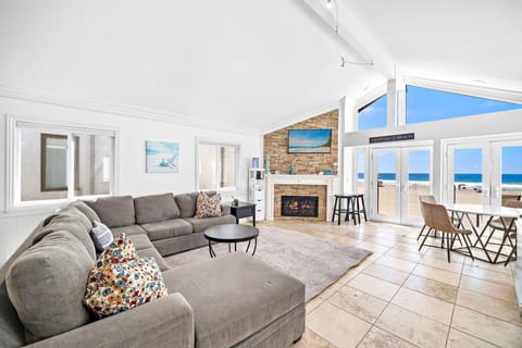 One of two living rooms in the rental, this second level living area includes a large sofa, cable TV, dining table for four, and French doors that lead to your beachfront patio.
                