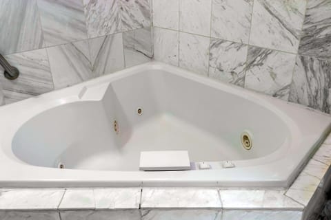 Suite, 1 King Bed, Jetted Tub | In-room safe, iron/ironing board, travel crib, rollaway beds