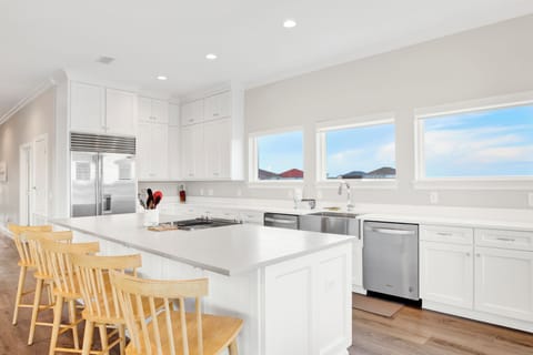 The kitchen is fully equipped and offers stone counters and stainless appliances