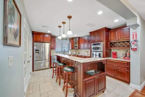 Kitchen with open lay out and island. Full set of appliances and coffee station.