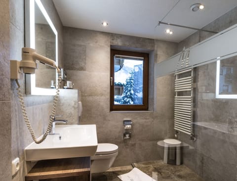 Shower, hair dryer, slippers, towels