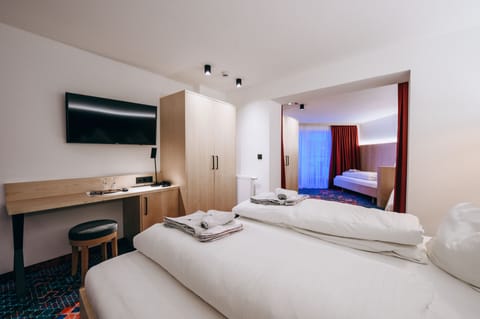 Family Quadruple Room | Minibar, in-room safe, desk, blackout drapes