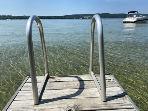 Beautiful view from the dock of the crystal clear lake with sandy bottom.  