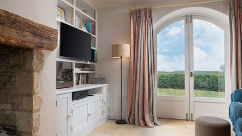 French doors and wide windows invite the outside in, opening onto the garden.