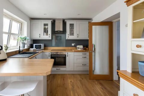 Fully fitted kitchen with oven, hob, microwave, dishwasher and fridge freezer.