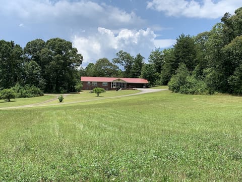 The house overlooks a grassy field