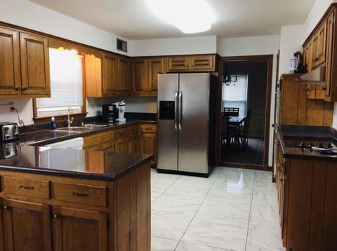 Full kitchen with pots, pans, utensils, and spices for basic cooking.  