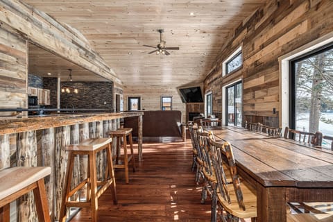 Rustic wood beams and natural stone create your cozy mountain retreat with open kitchen and dining space.