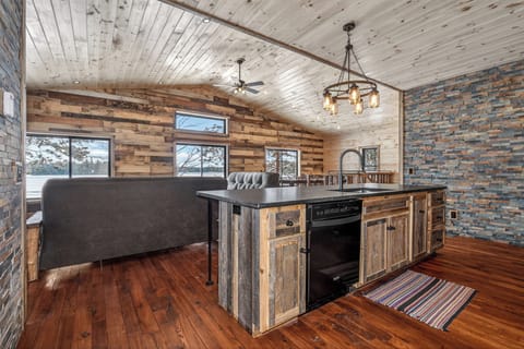 Step into your rustic-modern kitchen where reclaimed wood meets sleek stone, perfect for cooking memorable meals together.