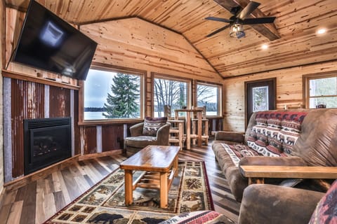High-ceilinged living area w/ big windows to over sea the lake
