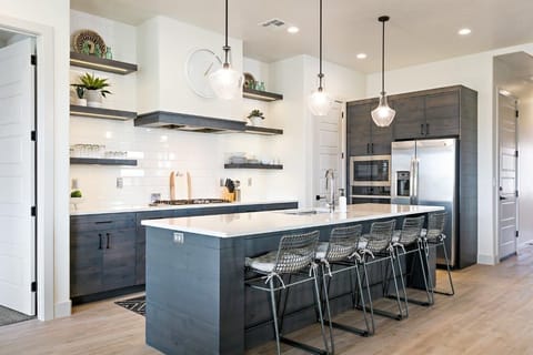 Spacious kitchen stocked with utensils and appliances for cooking