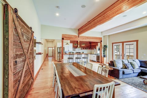 Spacious and open Great Room with high ceilings, exposed beams and original soft fir floors