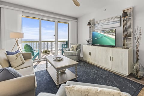 Relax in your coastal living room with stunning ocean views, comfortable seating, and a private balcony for morning coffee.