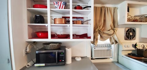 Pots, pans, and air conditioning in kitchen. 