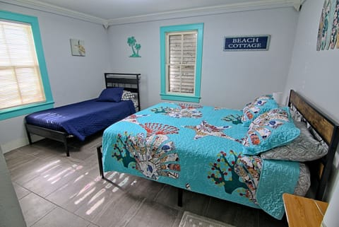 Spacious bedroom with queen bed, twin bed, and coastal charm