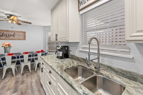 Fully-stocked and well-appointed kitchen with custom granite & cabinets, dining room, and more. Located on 2nd floor (main floor).