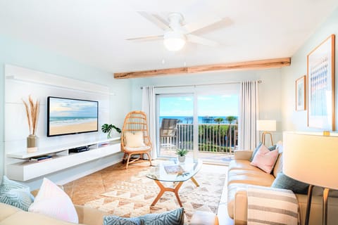 A beautiful coastal living room with ocean views and a walkout balcony