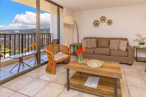Relax in this cozy living room with city views from the balcony.