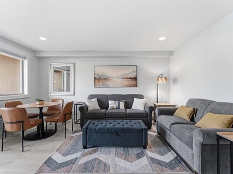 Picture yourself unwinding on plush sofas after your day's adventures, with warm lighting and peaceful artwork setting the perfect retreat vibe. The dining area invites memorable meals together.