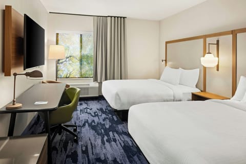 Premium bedding, desk, laptop workspace, blackout drapes