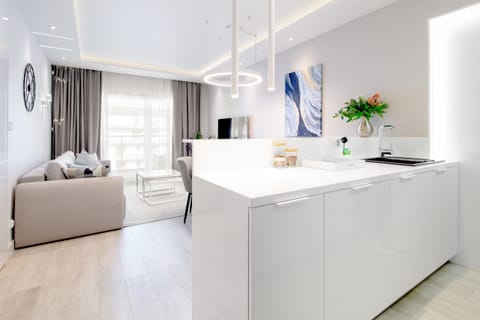 A comfortable living room with floor-to-ceiling windows allowing ample light and ocean views.