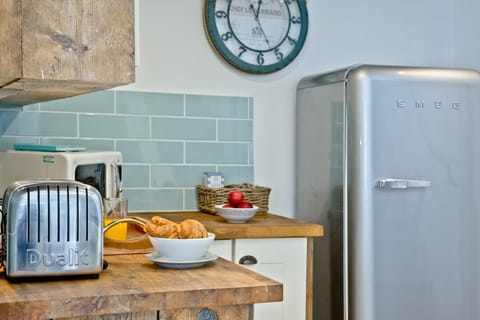 Kitchen with toaster, microwave - Birdcage Cottage