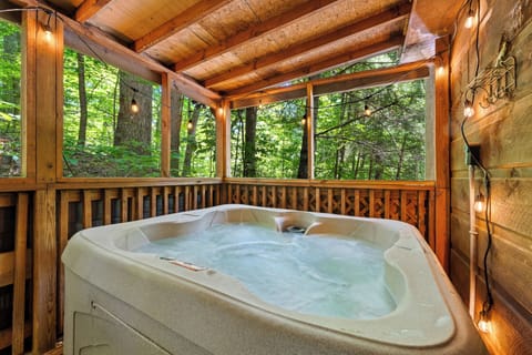 Soak away stress in the private hot tub with a forest view—pure mountain bliss.