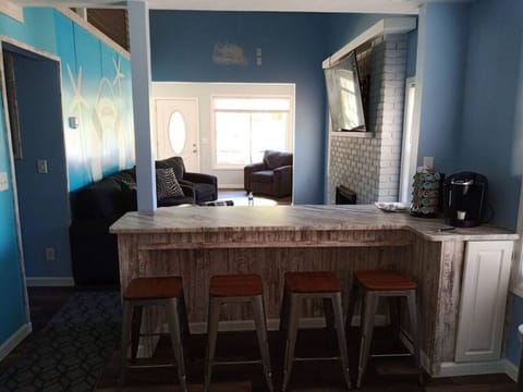 View of snack bar and living room from kitchen